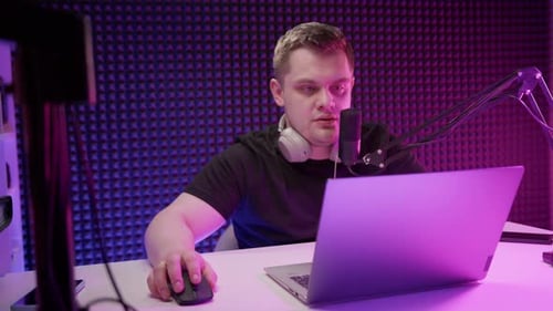 Man with Microphone at Desk Broadcasting