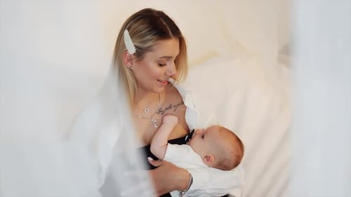 Mother Holding Baby with Love Indoors