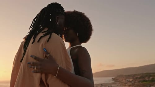 Couple Embrace on Beach at Sunset