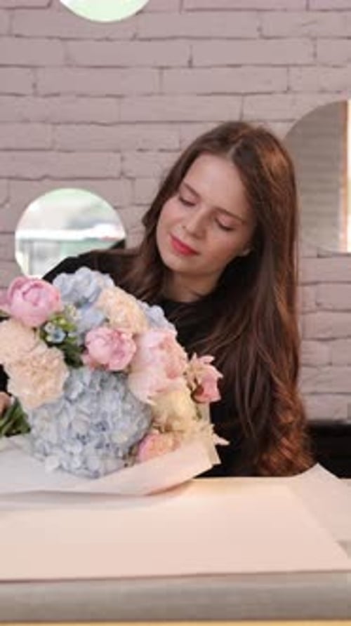 Young Woman Arranging a Beautiful Flower Bouquet