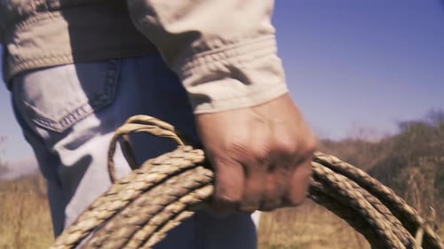 A Rancher Gripping a Rope While Preparing to Rope Cattle on an Argentine Ranch - 4K