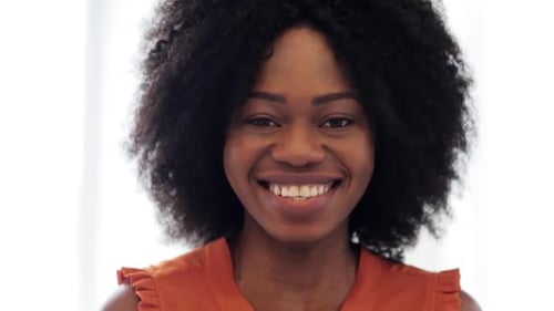 Smiling Woman with Dark Curly Hair Close Up