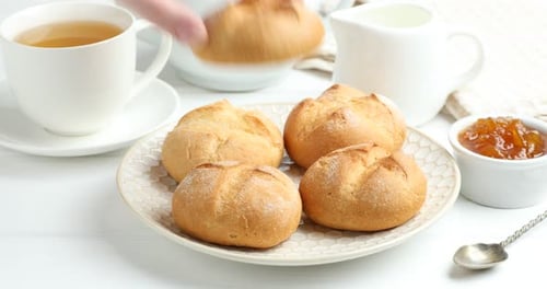 Golden Bread Rolls with Tea and Marmalade for Breakfast