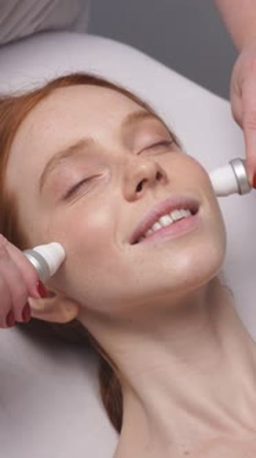 Woman Receiving Cosmetic Facial Treatment in Beauty Clinic