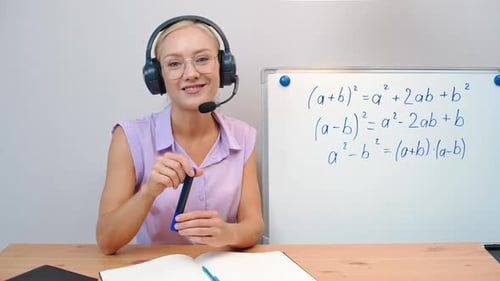 Woman Teaching Math Online with Headset and Whiteboard