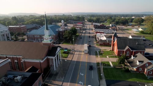 Shepherdsville Kentucky aerial with churches in foreground flying toward the courthouse