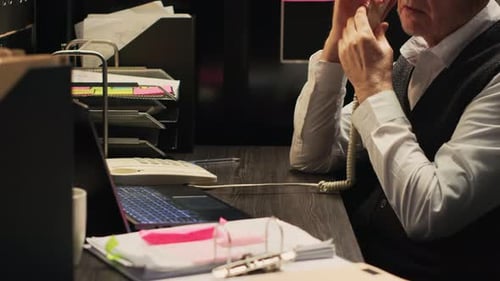 Senior Man Talking on Phone in Office