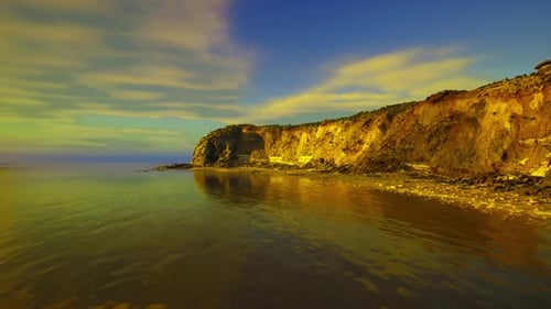 Calm Ocean Bay with Cliffs at Golden Hour