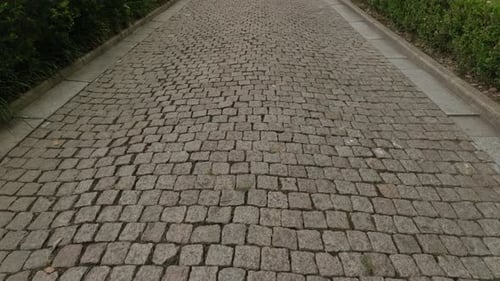 Waling on Road Made of Cobblestones an Oldstyle Pavement