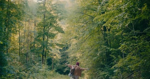 Carefree Female Hiker Exploring Forest