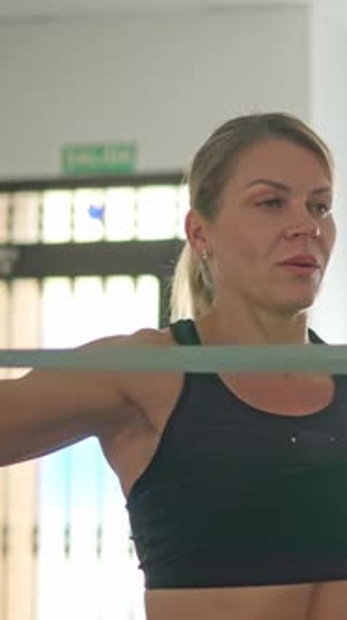 Woman Exercising with Resistance Band in Interior