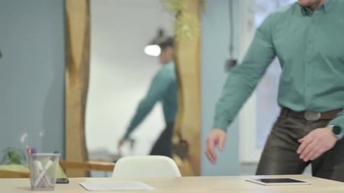 Mature Adult Man Coming Back to Office Desk
