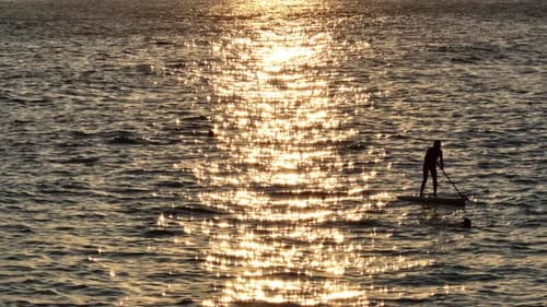 Paddle Boarding on Ocean at Sunset