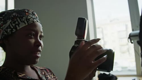 Black Female Photographer Working in Studio