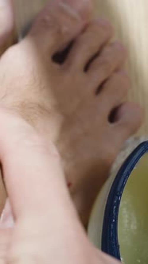 Applying ointment to foot cuts in close up shot