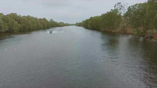 Drone shot over the Wakeboarder Towing Boat on the river. waterski videos.