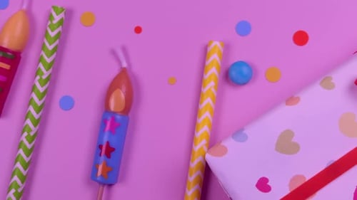 Moving Holiday Items of Candles Gift Boxes and Confetti on Pink Background Girl or Woman Birthday