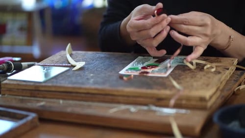 A woman making a stained glass work