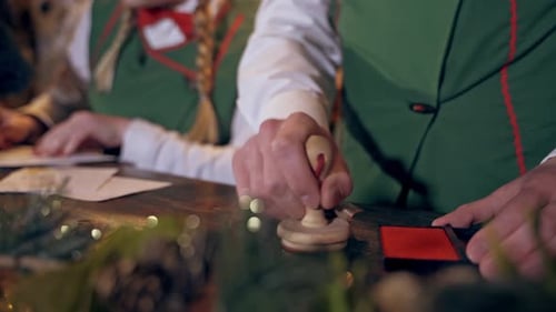 People Stamp Christmas Letters at Holiday Workshop