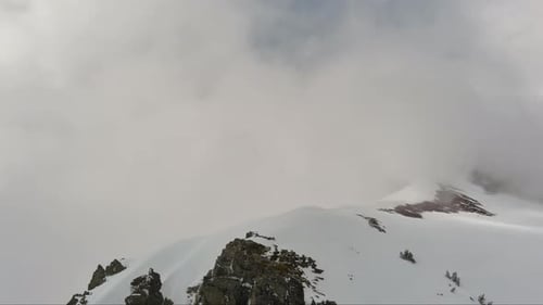 Snowy Mountain Peak Through Clouds. British Columbia, Canada.