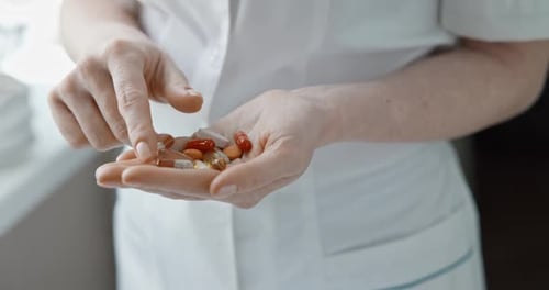 Pills in Hand of Medical Worker
