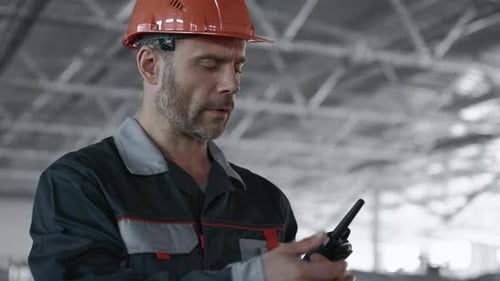 Engineer Planning Process of Machine Manufacture. Male Person in Hardhat or Protective