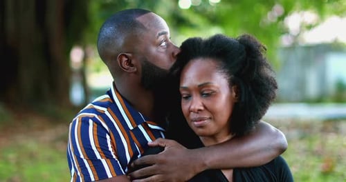 Loving Couple Embracing in a Park on Sunny Day