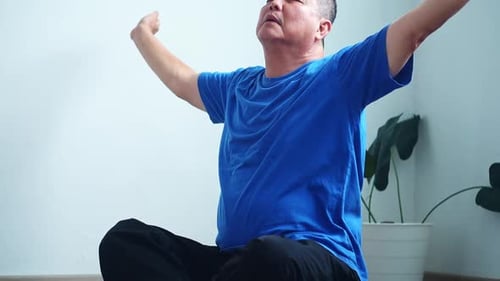 Mature asian man practicing mindfulness and meditation for inner peace and well-being at home