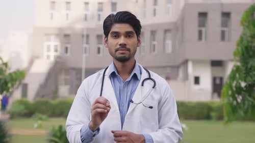 Doctor in White Coat Talking Outdoors