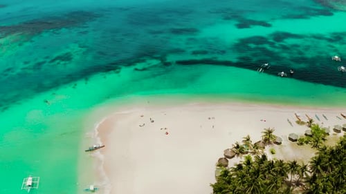 Tropical Daco Island with a Sandy Beach and Tourists