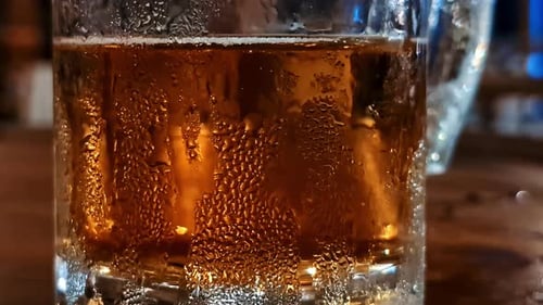 Pitcher of cold beer in a warm tropical setting