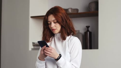 Woman Frustrated with Smartphone Pressing Against Forehead