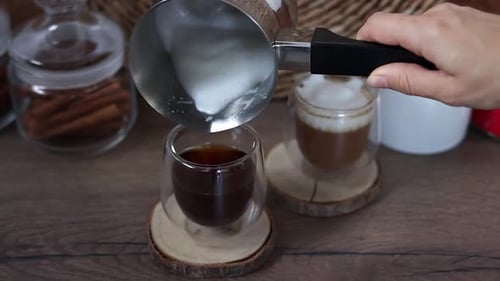 Pouring Frothy Milk into Coffee for Delicious Latte