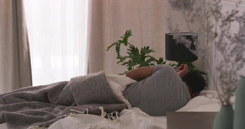 Man Wakes Up and Sits Up in Bed