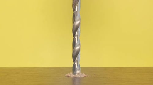A Selftapping Screw in a Wooden Block on a Yellow Background Screwdriver Screw Lag Bolt The Electric