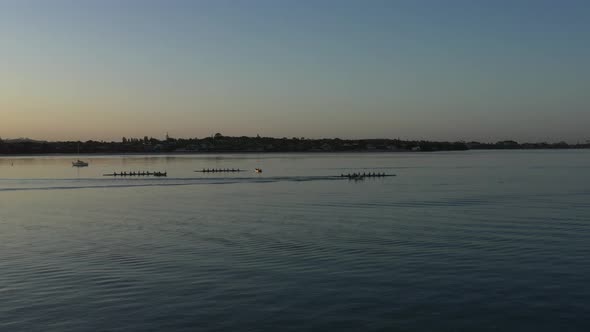 Scenic sunset aerial towards octuple rowing crews near Auckland, NZ ...