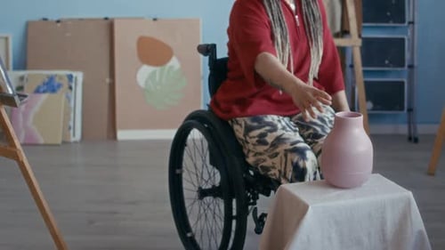 Creative Female Artist in Wheelchair Preparing to Paint Still Life in Studio