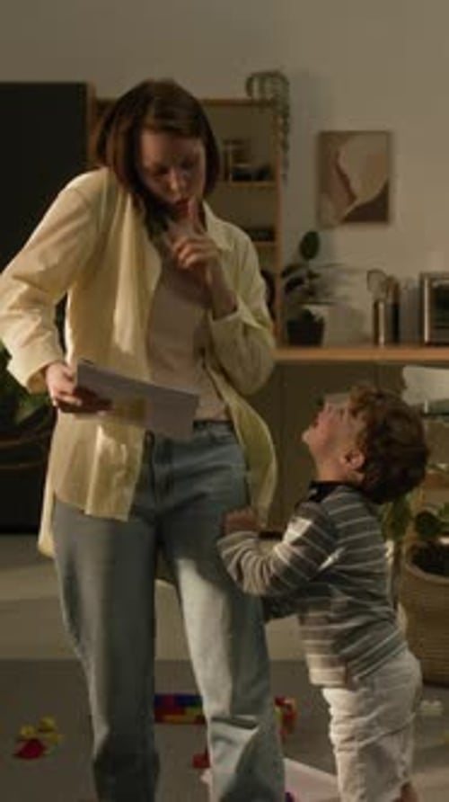 Woman on Phone as Child Pulls Shirt