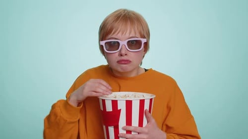 Enthusiastic Adult Eating Popcorn Wearing 3D Glasses