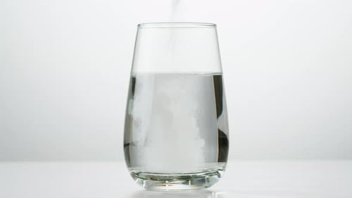 Effervescent Tablet Dissolving in Glass of Water