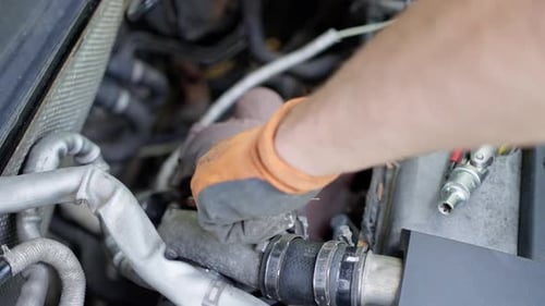 Car Mechanic Hands in Garage with Old and Used Turbocharger Turbine Concept Slow Motion
