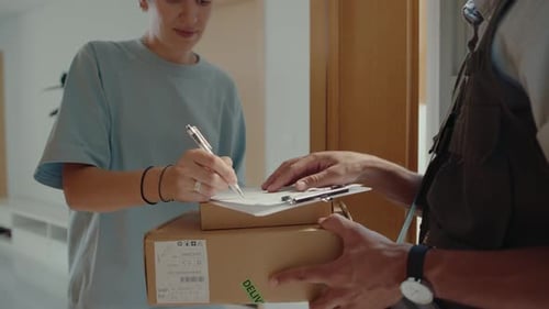 Delivery Woman Signing for Packages at Her Door