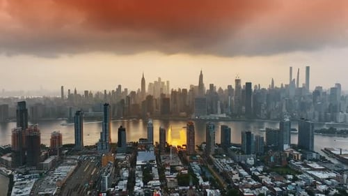 Overcast skies above Manhattan. New York downtown cityscape at orange sunset. Top view.