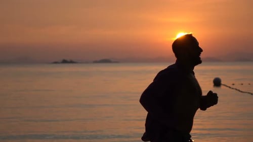 Happy Man Running on Beach at Sunset Slow Motion