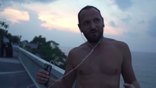 Happy Man Dancing While Listening to Music on Terrace, Super