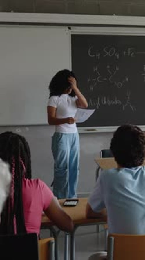 Young High School Student Girl Giving a Presentation in Front of His Classmates