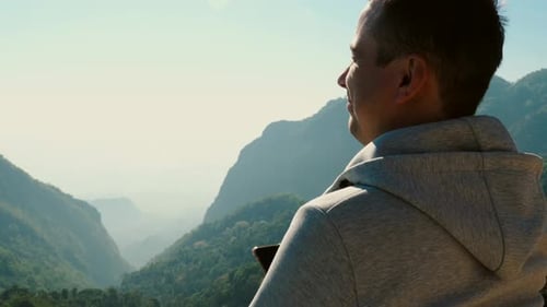 Man Gazing at Mountain Landscape in Bright Sunlight