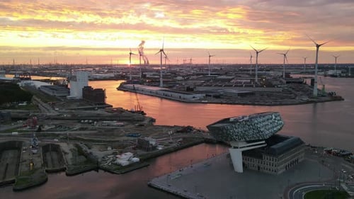 Aerial Hyperlapse during sunset with wind turbines and river