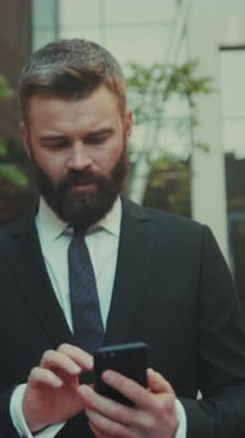 Corporate Professional in Formal Attire Conducts Affirmative Messaging in Lively Urban Environment
