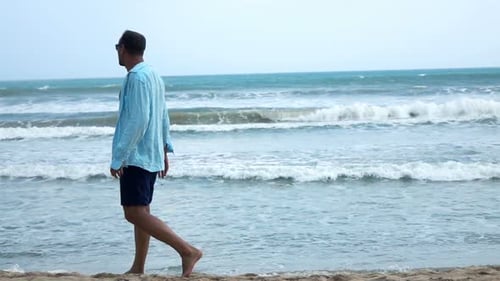 Young Man Relaxing and Walking on Beach, Super 240